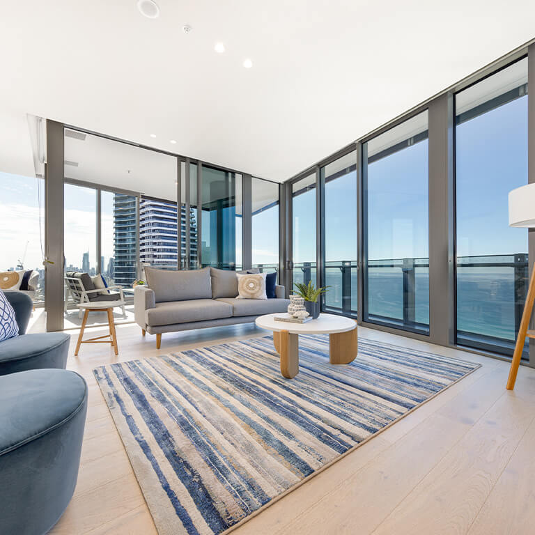 Luxury 3 Bedroom Ocean View Apartment at ULTIQA Signature at Broadbeach with spacious living area and floor-to-ceiling windows.